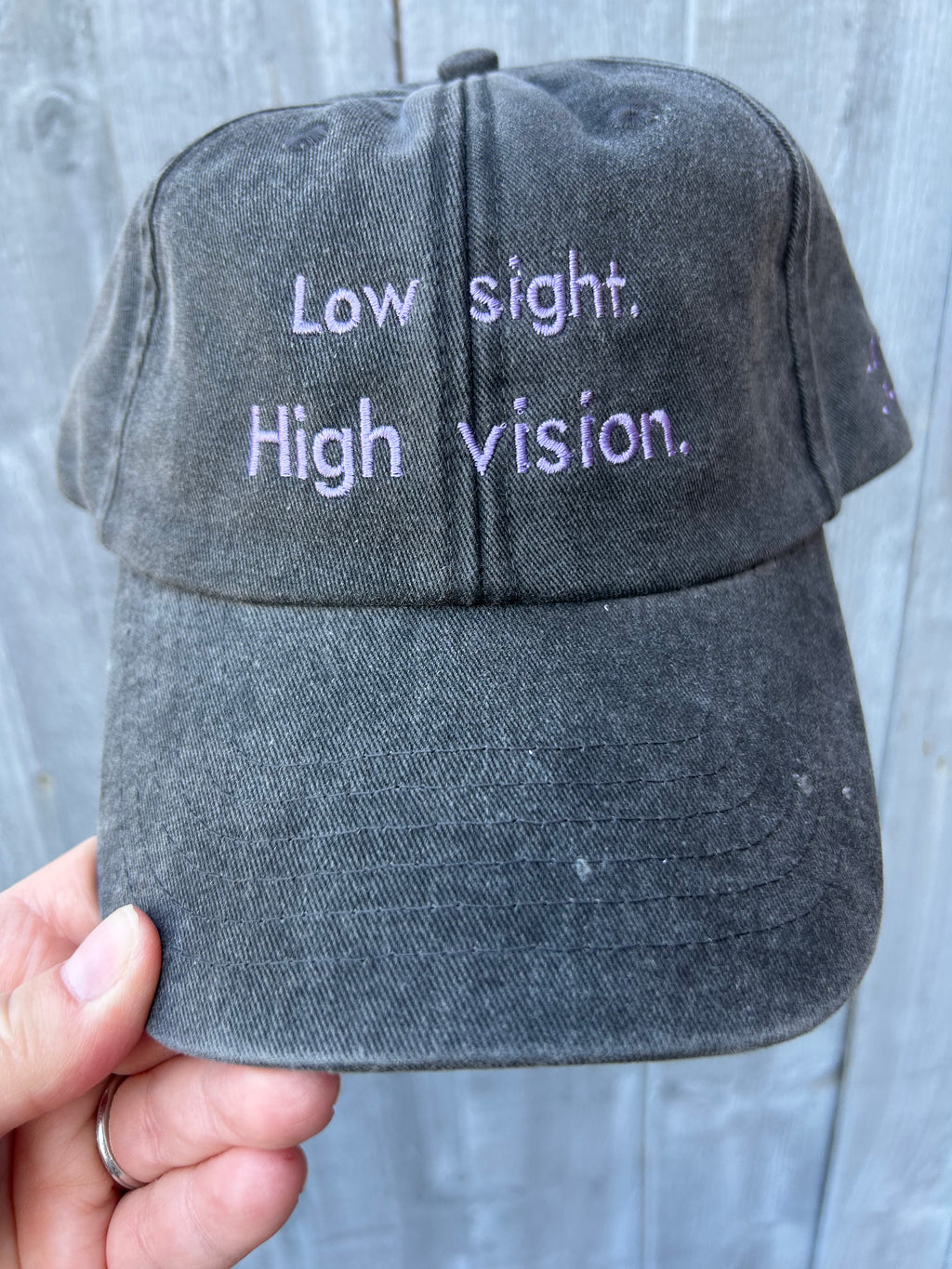 Low sight. High vision. Black and lavender 100% cotton cap.