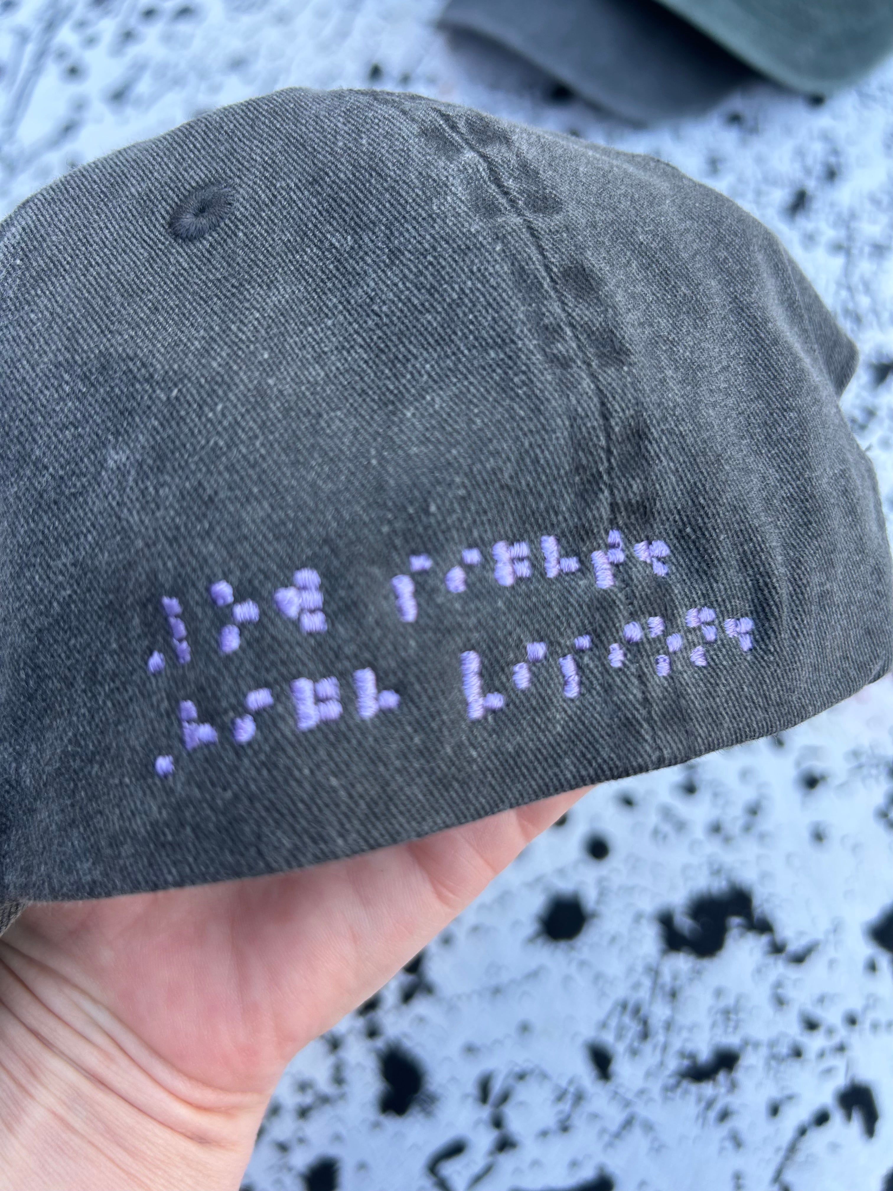 Low sight. High vision. Black and lavender 100% cotton cap.