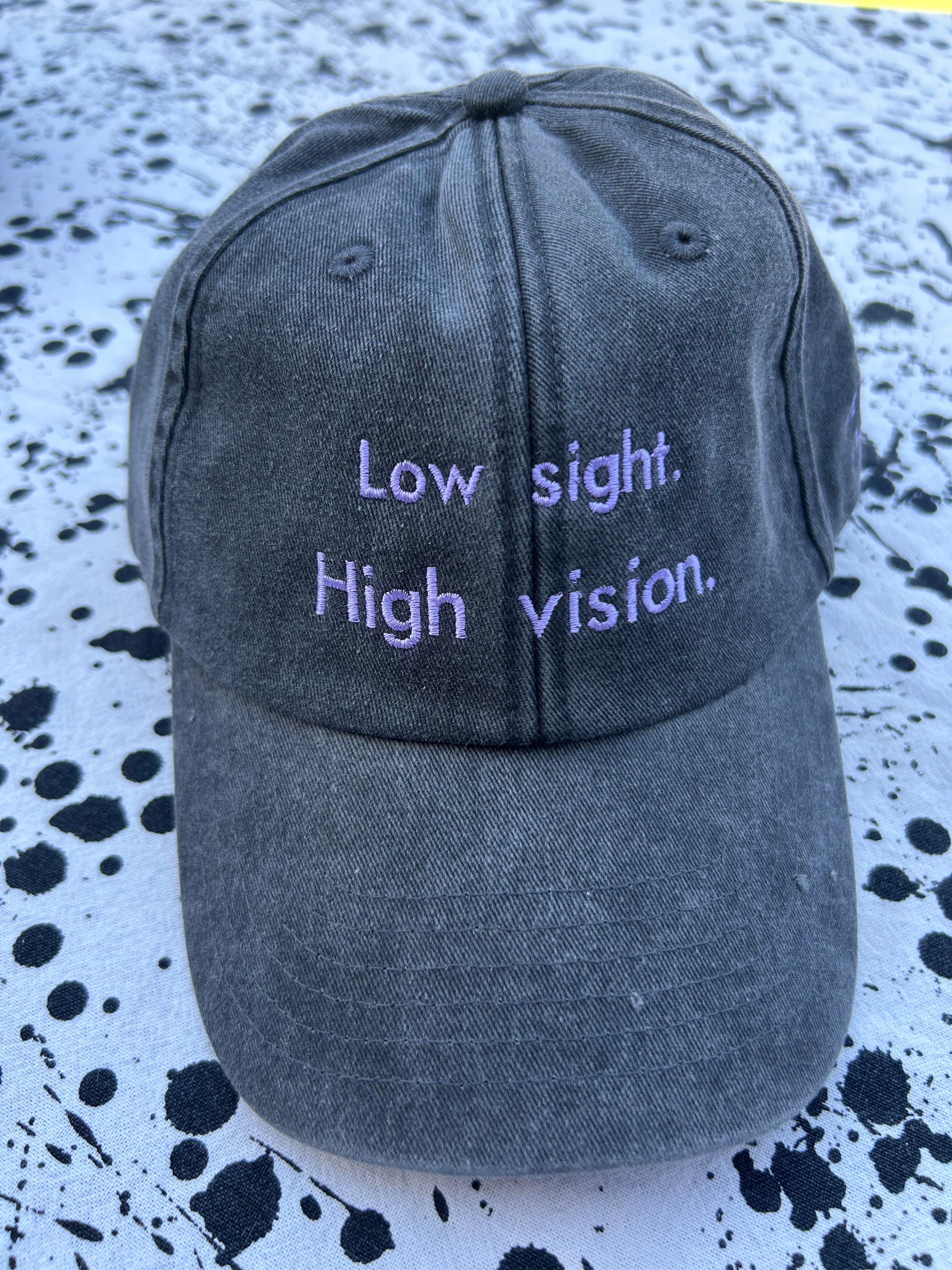 Low sight. High vision. Black and lavender 100% cotton cap.