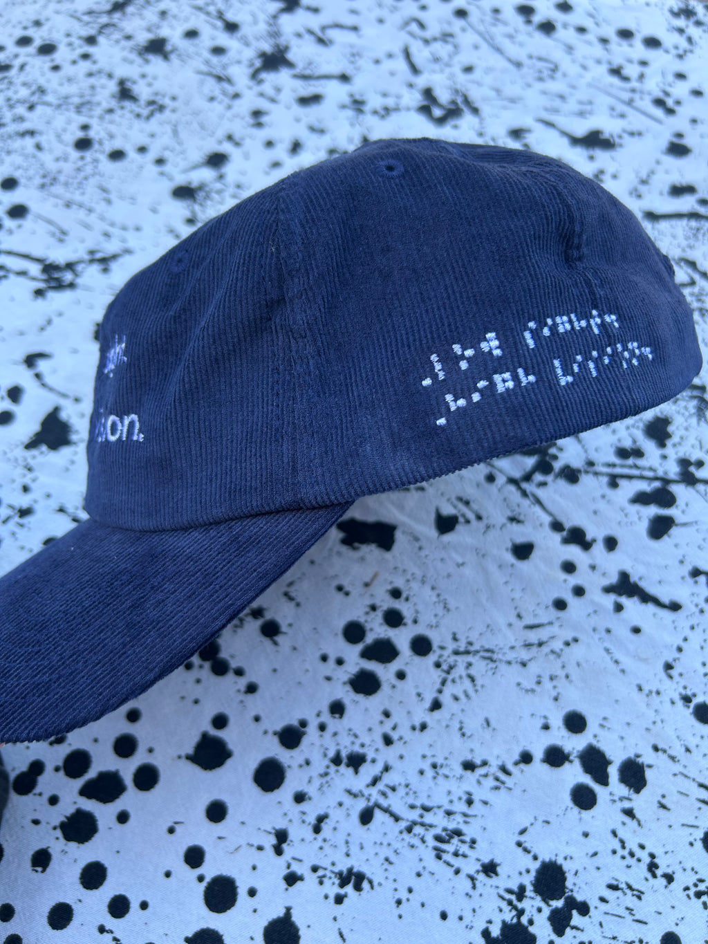 Low sight. High vision.  Navy cord 100% cotton cap with white embroidery