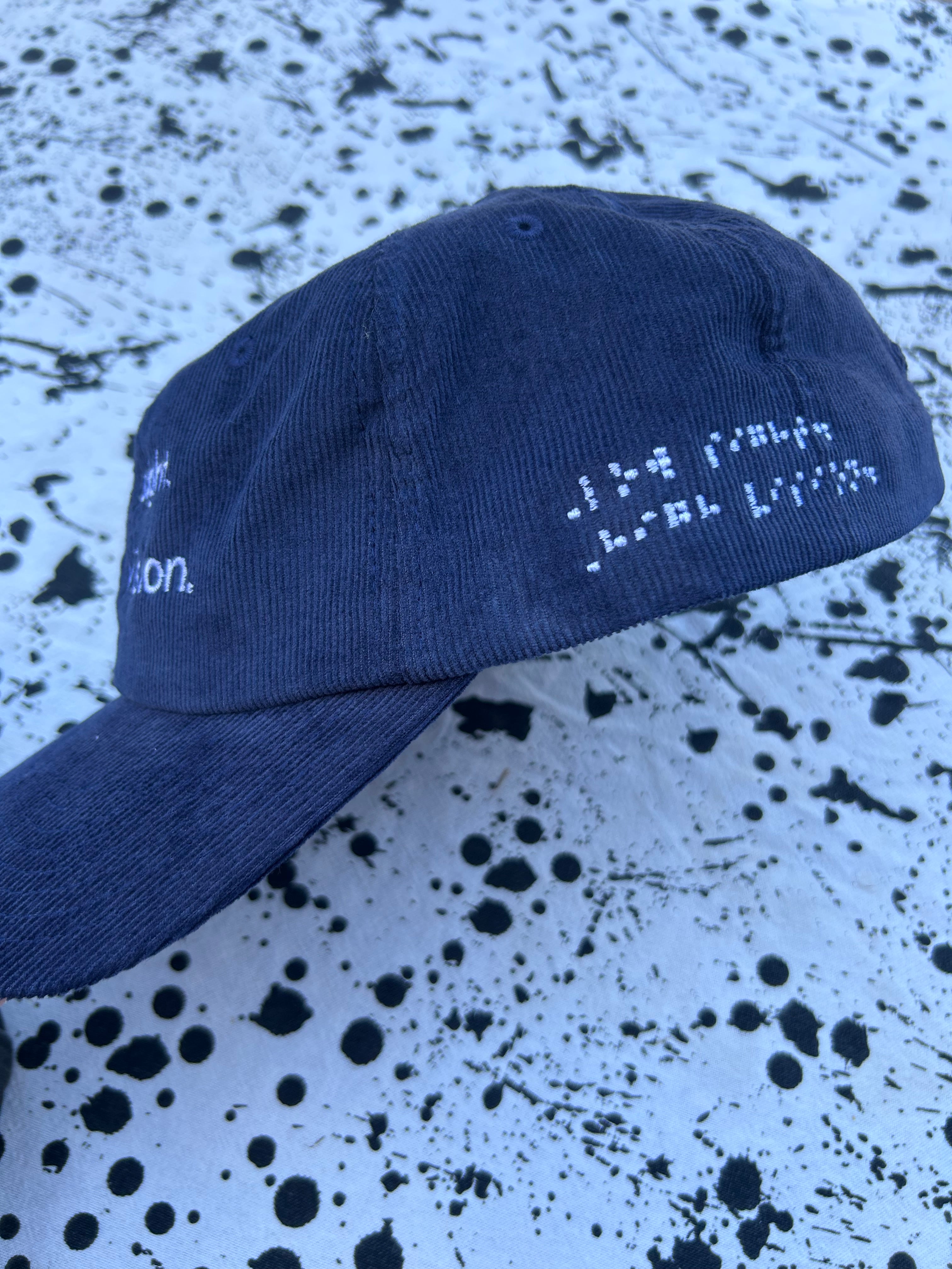 Low sight. High vision.  Navy cord 100% cotton cap with white embroidery