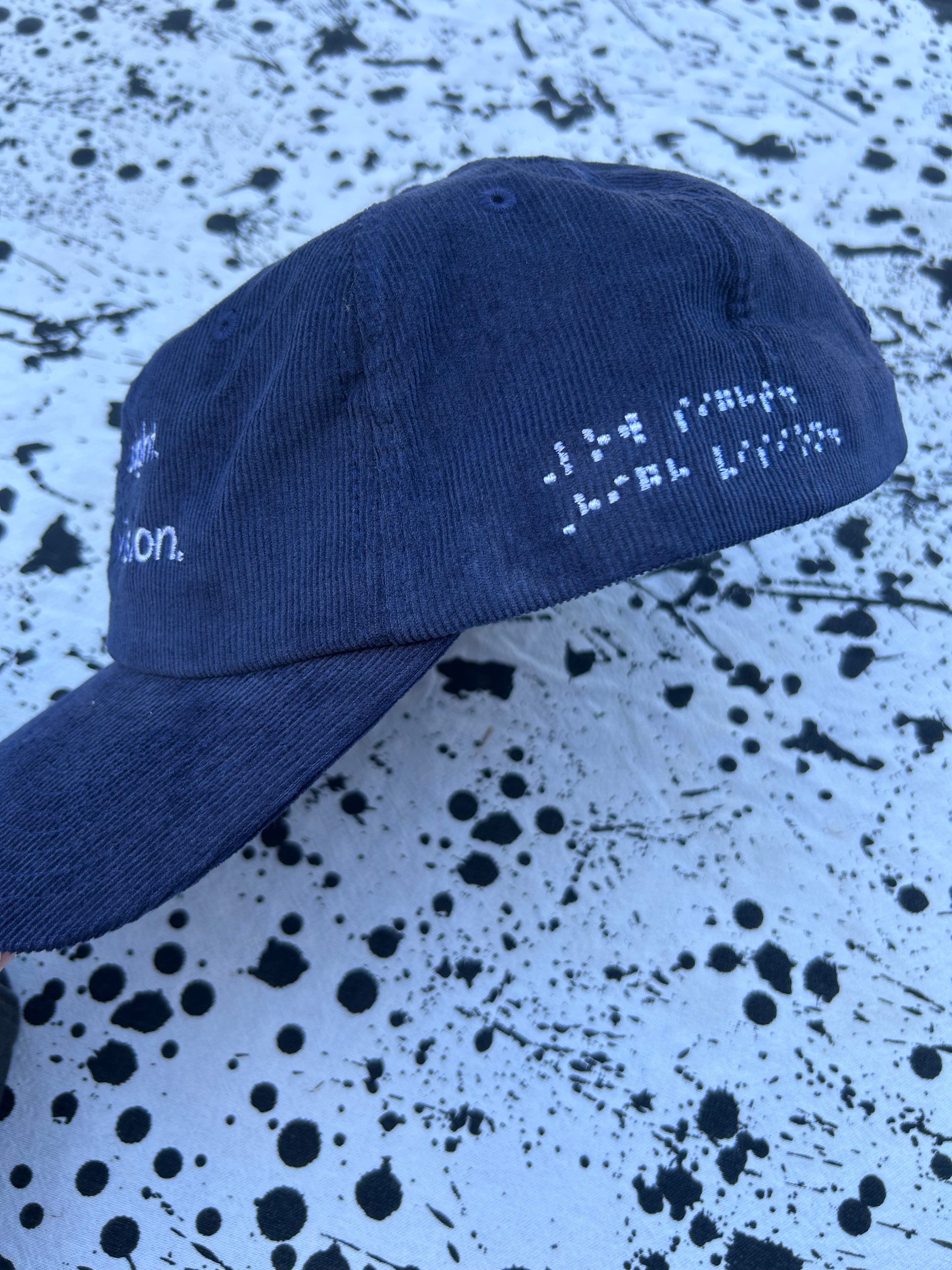 Low sight. High vision.  Navy cord 100% cotton cap with white embroidery