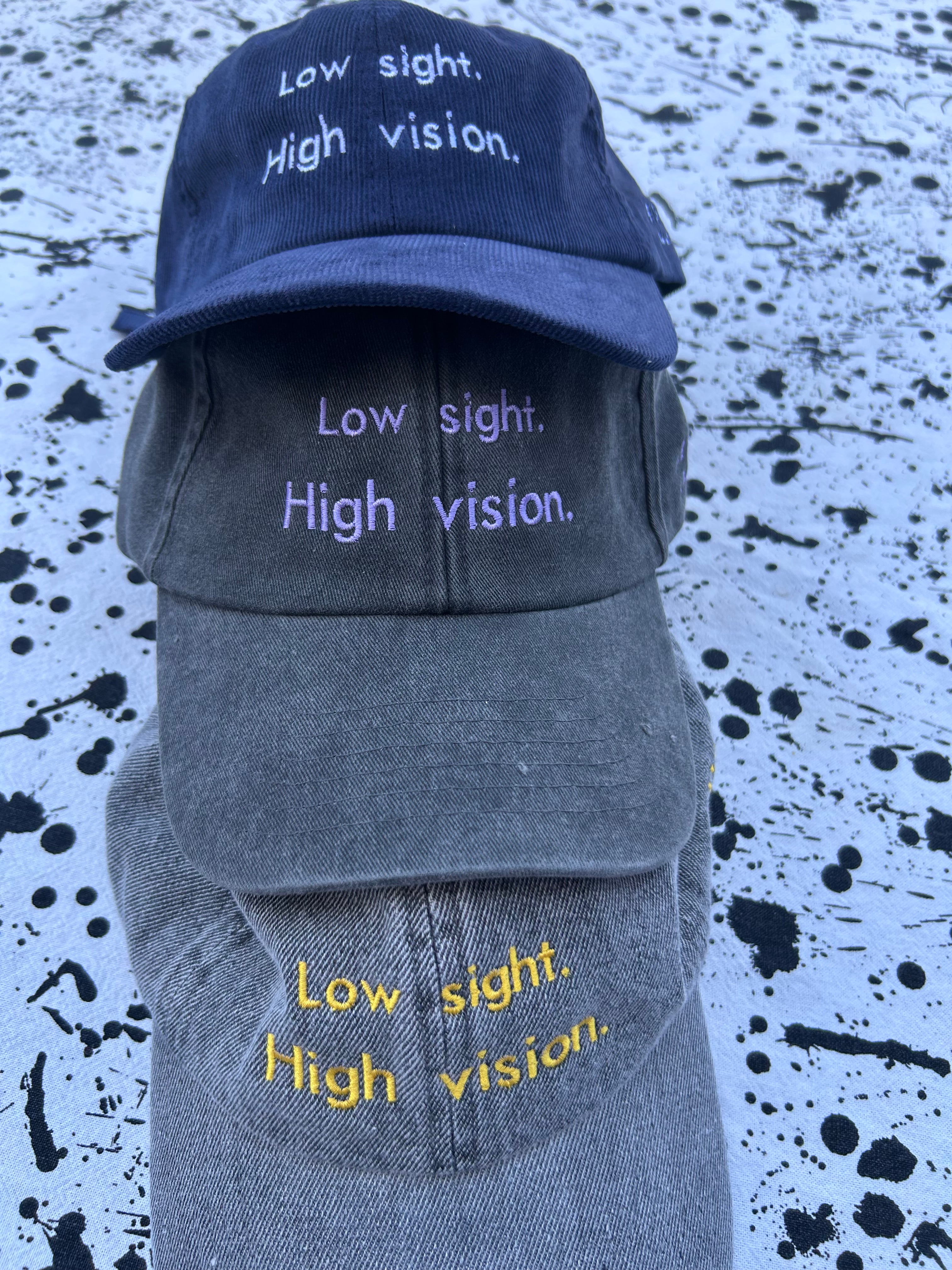 Low sight. High vision. Black and lavender 100% cotton cap.