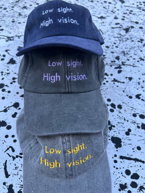 Low sight. High vision. Black and lavender 100% cotton cap.