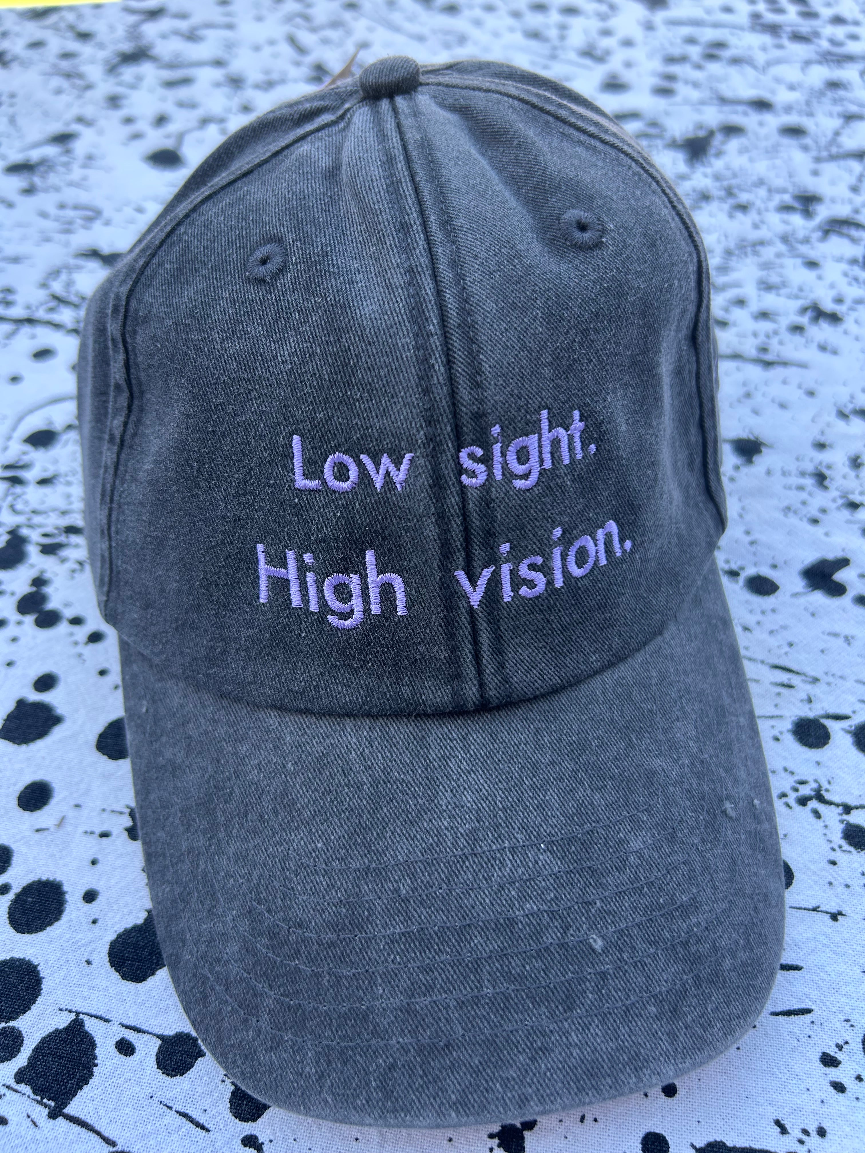 Low sight. High vision. Black and lavender 100% cotton cap.